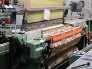 A mechanized loom producing blanket fabric in the Pendleton Woolen Mills